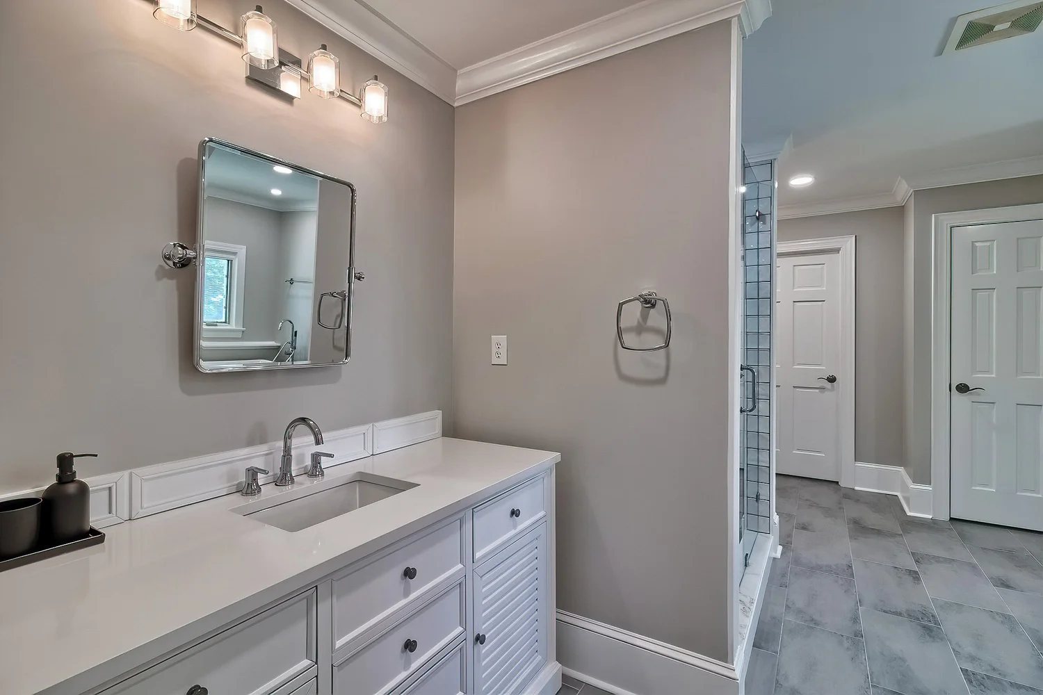 Clean bathroom vanity and shower area at Polaris Pointe.