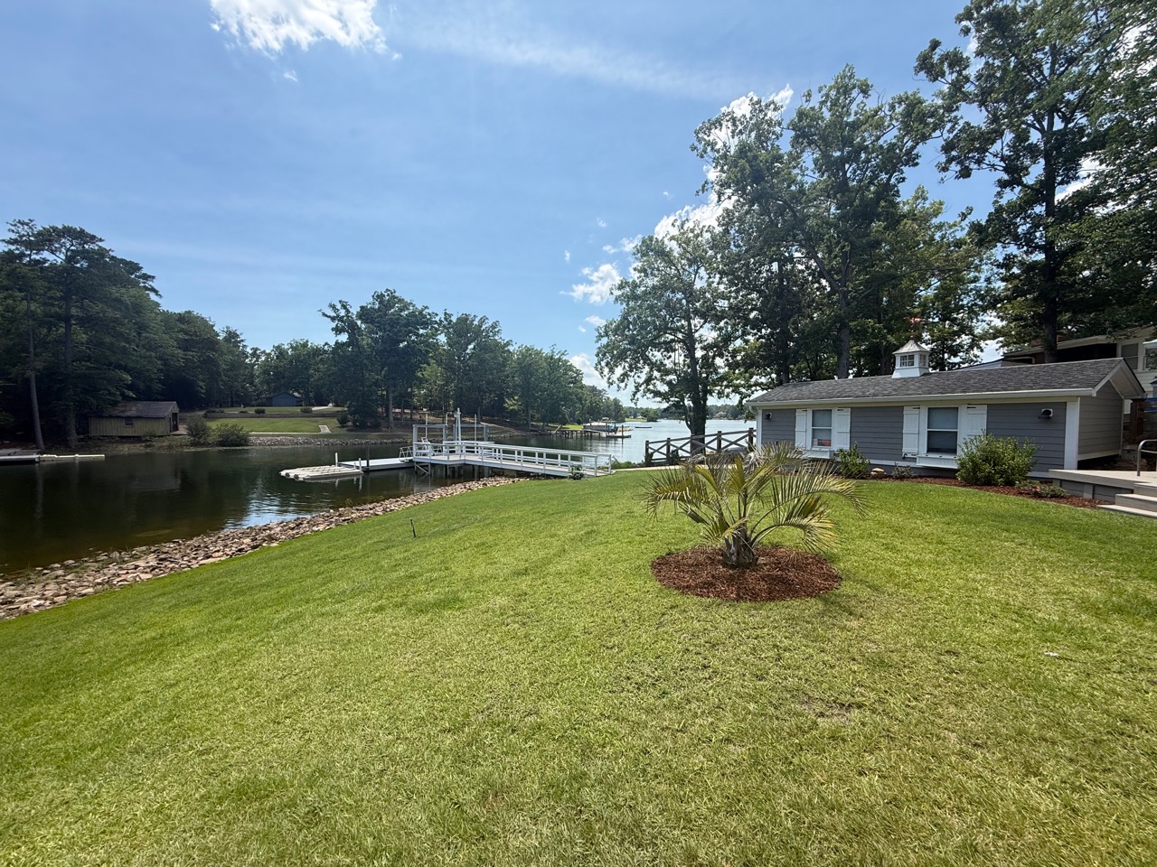 Boat house, lawn, dock, shoreline, and Lake Murray cove view at Polaris Pointe.