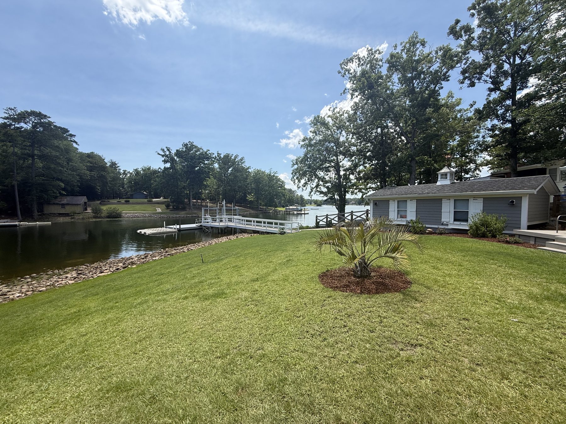 Private cove, boat house, lawn, and dock on Lake Murray.