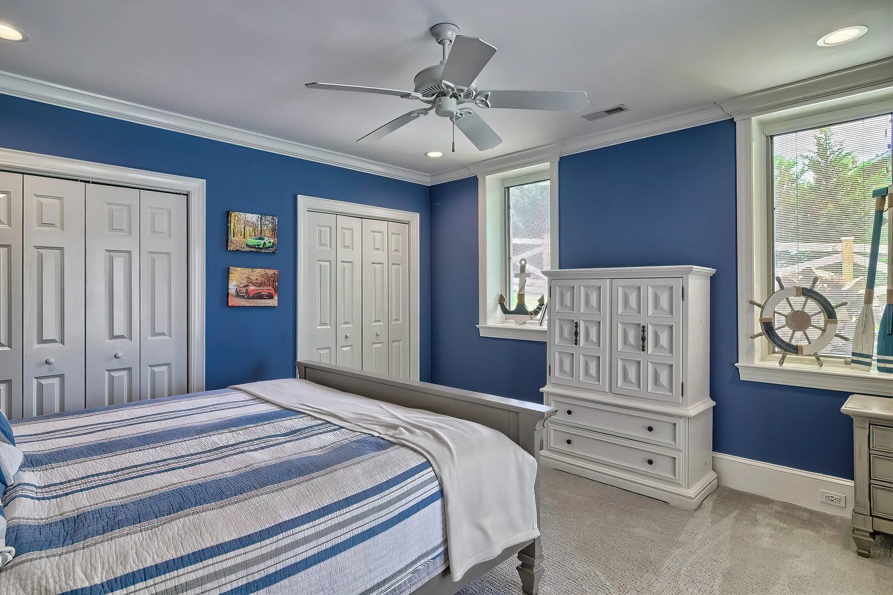 Comfortable living room with blue doors, lounge seating, and lake-house style.