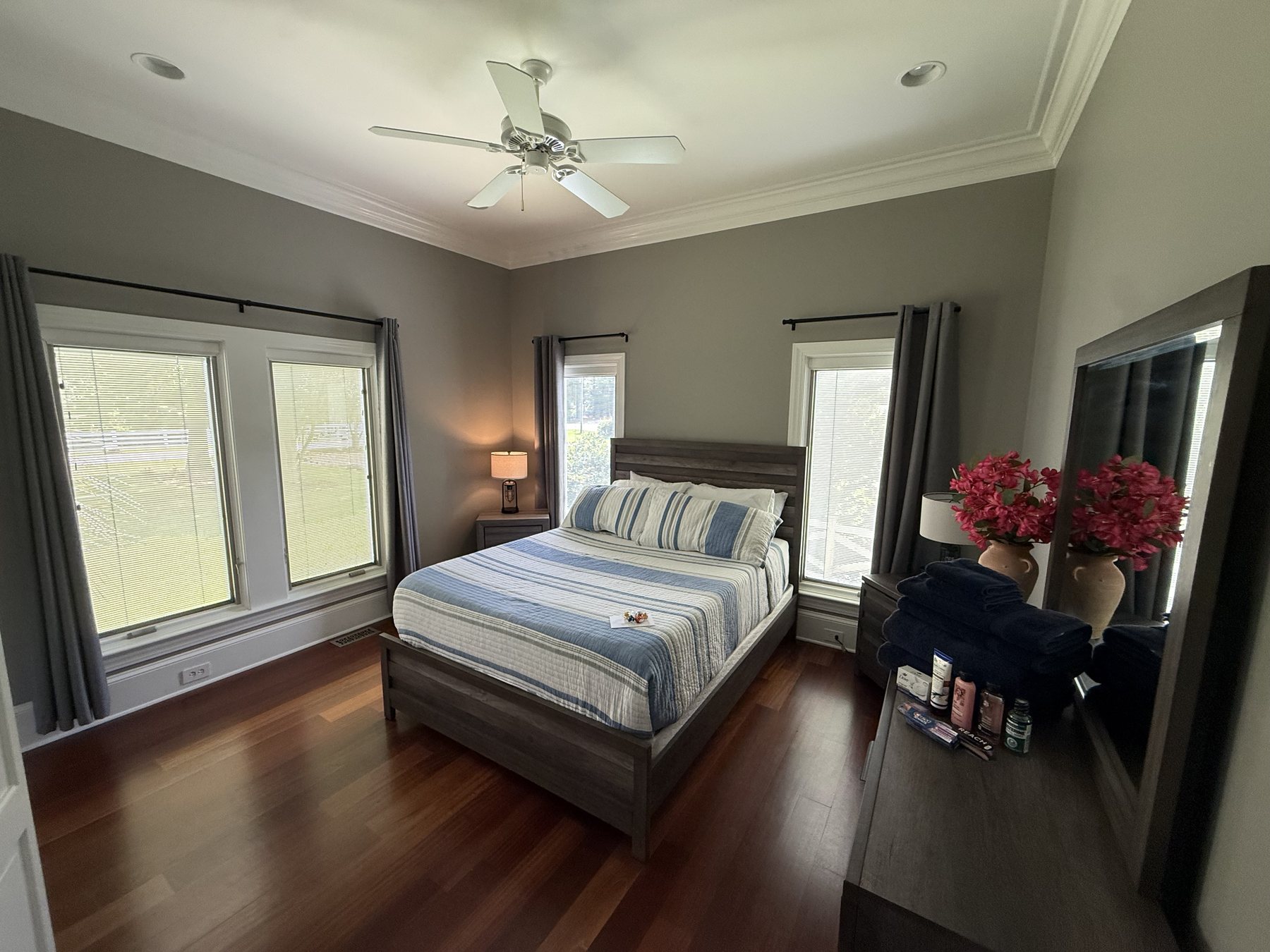 Guest bedroom with windows and polished bedding at Polaris Pointe.